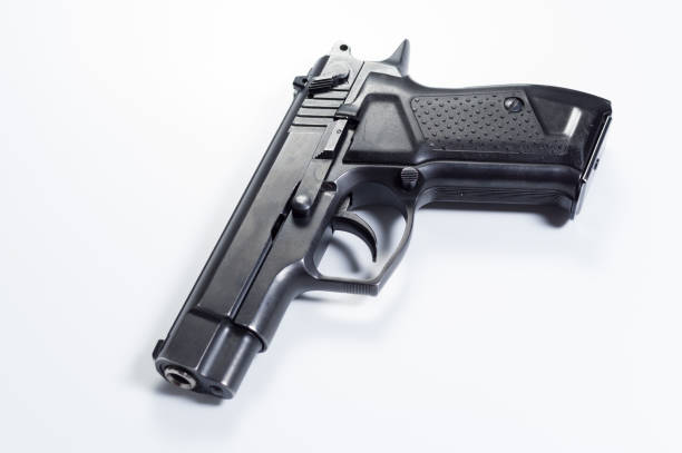 istock Fire pistol at an angle. Pistol on a gray background. 1139357613