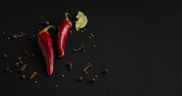 istock Red hot pepper and various spices on a black background. Flat lay copyspace. 1139358735