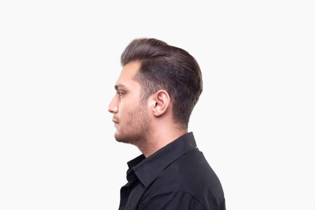 istock Profile view of a young man with blank expression over white background 1139359554