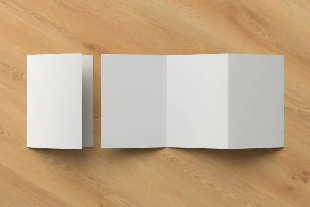 Blank trifold of three of A5/A4 pages brochure booklet on wooden background with clipping path around brochure. Folded and unfolded. 3D illustration