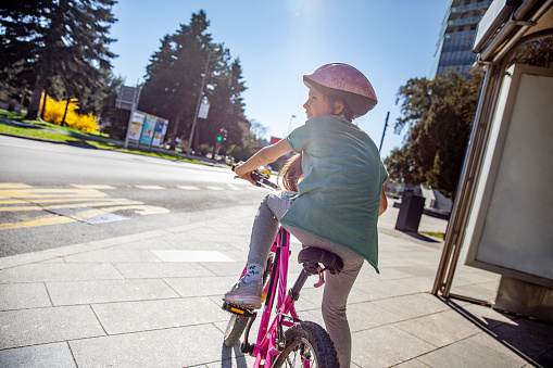 Little Girl Enjoying a bicycle ride in the City