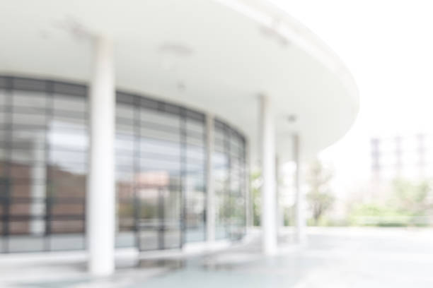 istock Office or university building blur background exterior view with blurry empty lobby space, entrance hall glass wall window and light bokeh 1139369744
