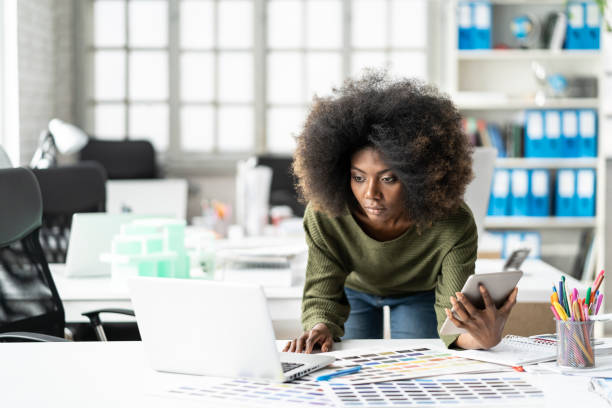 istock Female designer using laptop and color palettes in studio 1139370004