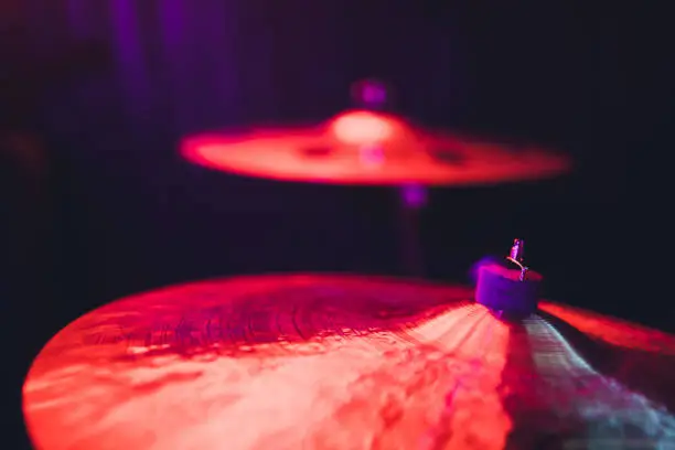 Photo of Drum kit on stage in the spotlight color.