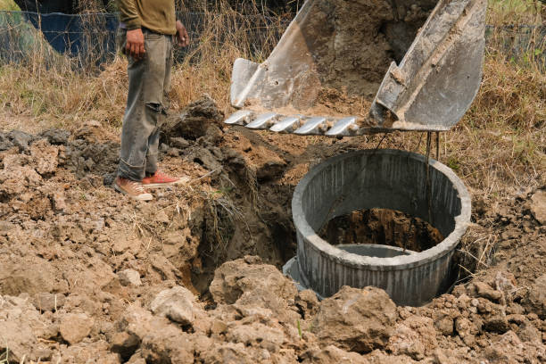 istock excavator backhoe burying pipe on ground at construction site 1139370510