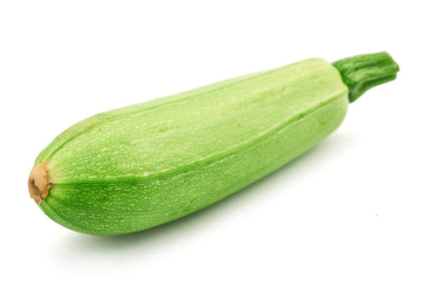 istock fresh green zucchini with slice isolated on white background 1139374954