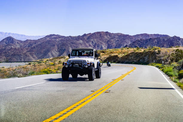 Jeep vehicle travelling on a highway March 17, 2019 Coachella Valley / CA / USA - Jeep vehicle travelling on a highway in south California motorcycle 4 wheels stock pictures, royalty-free photos & images