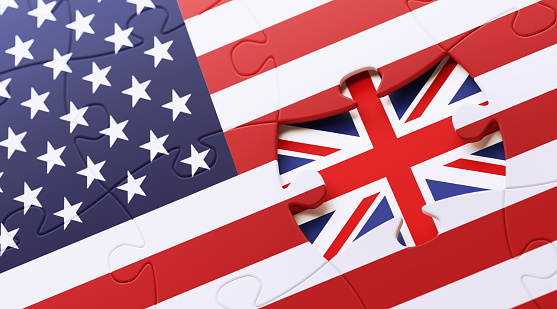 American and British flag puzzle. Horizontal composition with copy space and selective focus.