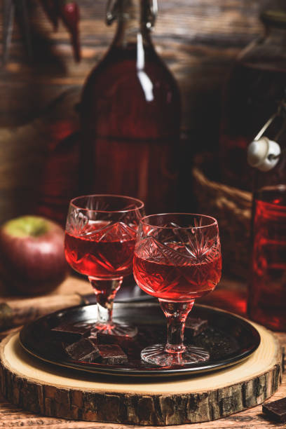 Glass of red liquor with chocolate bars Glass of red liquor with chocolate bars on metal tray nalewka stock pictures, royalty-free photos & images