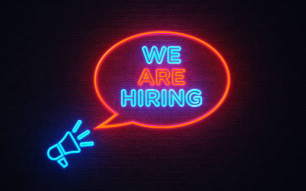 istock Megaphone Icon And We Are Hiring Shaped Neon Light On Black Wall 1139379094