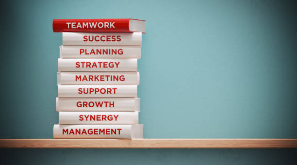 istock Books of  Teamwork And Marketing In Front Grey Wall 1139379513