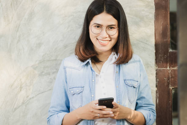 istock woman using smartphone in free time. 1139384370