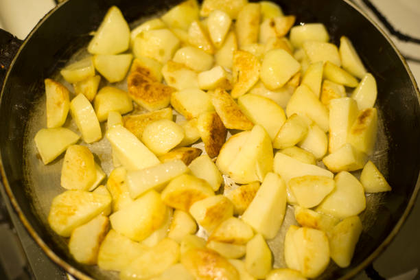 istock potato slices are fried in a pan until golden brown 1139386112
