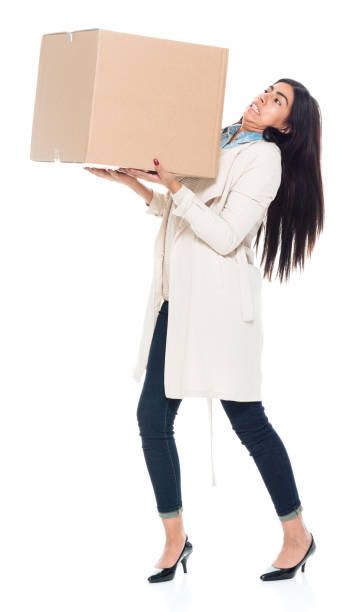 istock Attractive young latino female is holding a box 1139391636