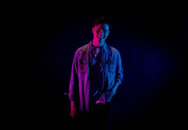 istock Good looking man wearing a button down shirt in front of black background 1139395396