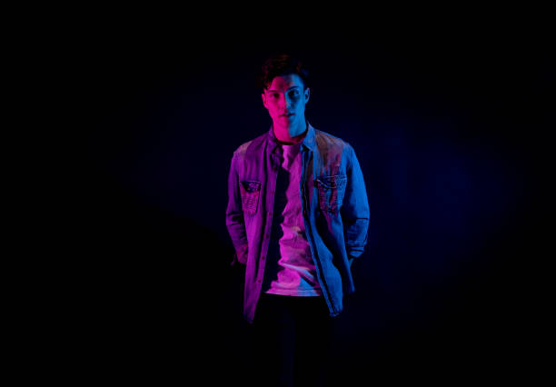 istock Good looking man wearing a button down shirt in front of black background 1139395405