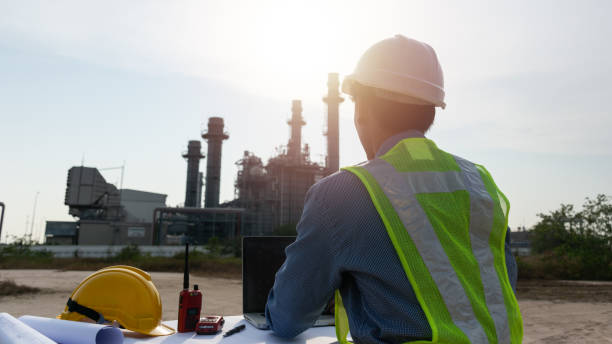 istock Engineers male working with laptop for workers security control at power plant. Energy power station area with sky, sunset. Concept safety,industry 1139396488