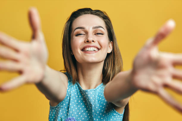 Beautiful happy woman with open hand ready for hugs