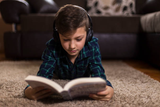istock Boy reading book in his room 1139406349