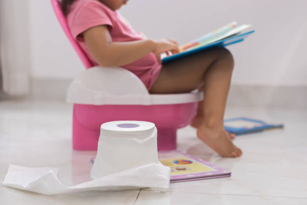 Toddler potty training. reading books on the toilet. Smart kids. Learning how to read. Toilet training. Child with toilet paper, potty, and books. potty toilet child bathroom stock pictures, royalty-free photos & images
