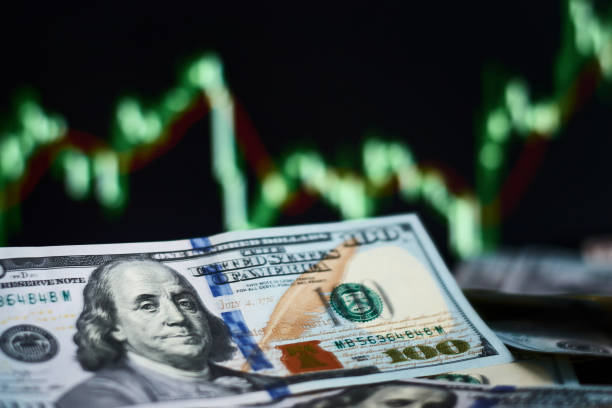 istock Closeup dollar banknote with screen stock exchange data graph background. Finance and a business concept 1139412782