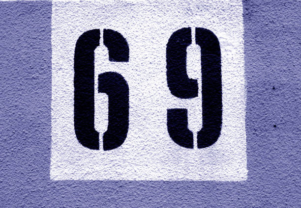 istock Number 69 on cement wall in stencil in blue tone. 1139420690