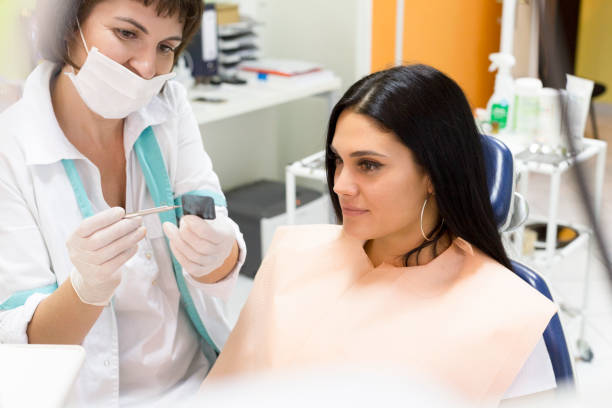 istock Dentist looking at an x-ray with a patient 1139422734