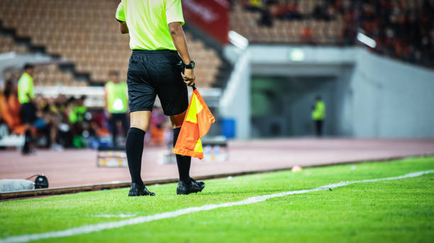 Linesman assistant referee action in the soccer stadium during match Linesman assistant referee action in the soccer stadium during match offside stock pictures, royalty-free photos & images