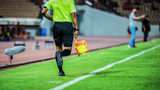 Linesman assistant referee action in the soccer stadium during match