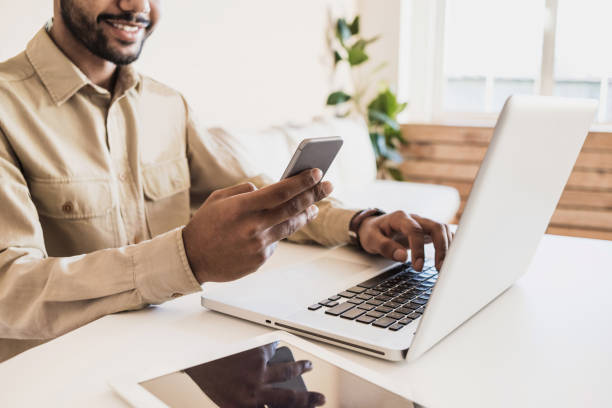 istock Men working at home. Freelancer using laptop and smartphone 1139425832