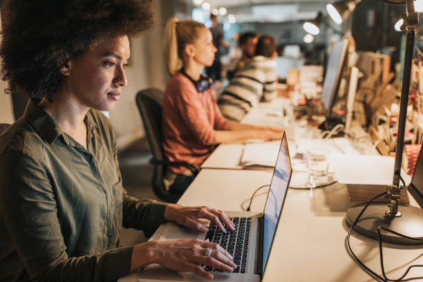 istock African American female programmer working on laptop in the office. 1139426138
