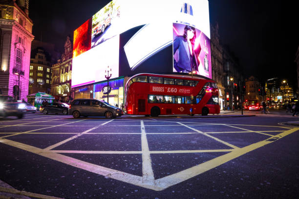 London, United Kingdom - March 8, 2015: Coventry Street near Picadilly Circus at night. The blur of people can be seen.