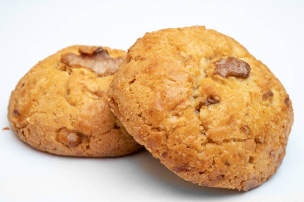 istock Fresh, tasty, round cookies with walnuts on a white background. 1139430309