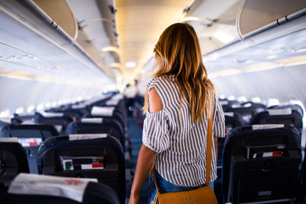 rear view of a woman in an airplane. - entering airplane imagens e fotografias de stock