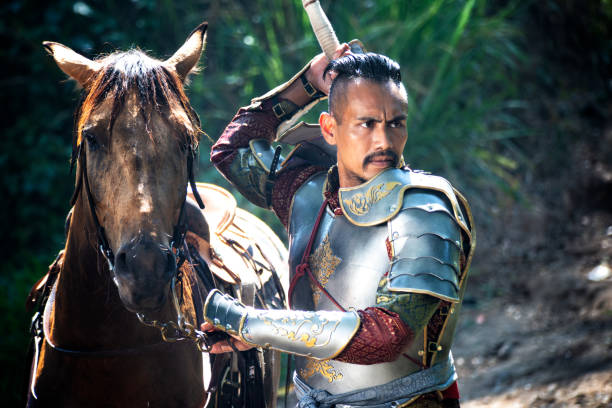 istock Man In Warrior Costume Removing Weapon By Horse 1139433154