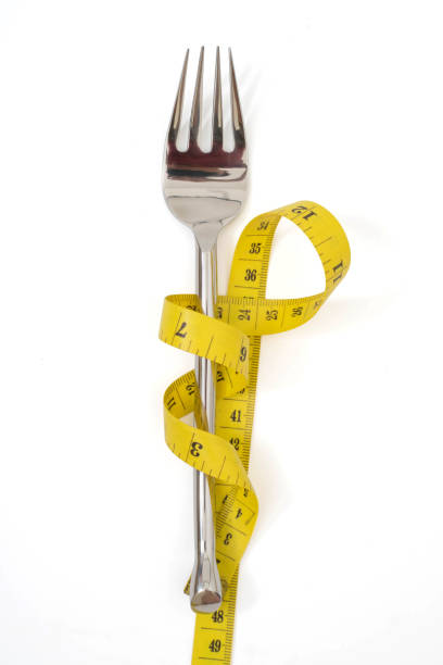 istock fork with a measuring tape diet or healthy eating concept concept 1139439008