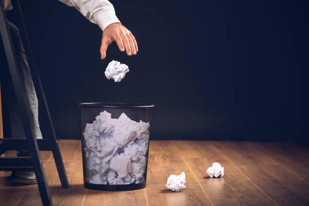 man throwing away papers into trash bin, inspiration, creativity and idea concept for business - paper crumpled document garbage imagens e fotografias de stock