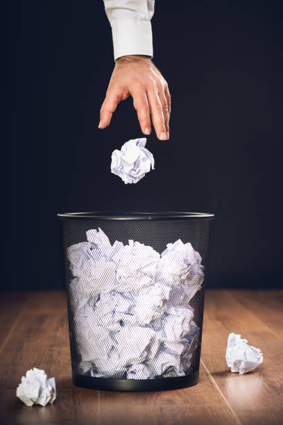 istock Man Throwing Away Papers into Trash Bin, Inspiration, Creativity and Idea Concept For Business 1139439382