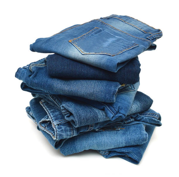 istock Lot of different blue jeans isolated on white 1139442744