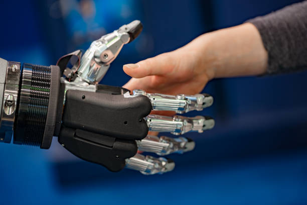 istock Hand of a businesswoman shaking hands with a Android robot. 1139444330