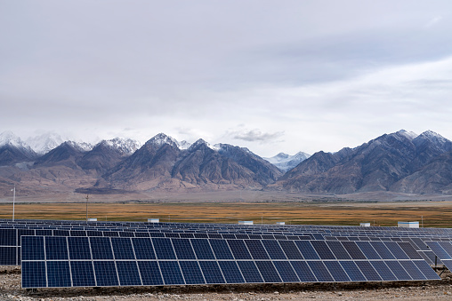 Solar power generation on snowy mountains and cloudy skies in the background