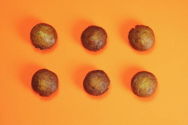 istock Banana cake pasted on an orange background, candy layout patterns 1139445337