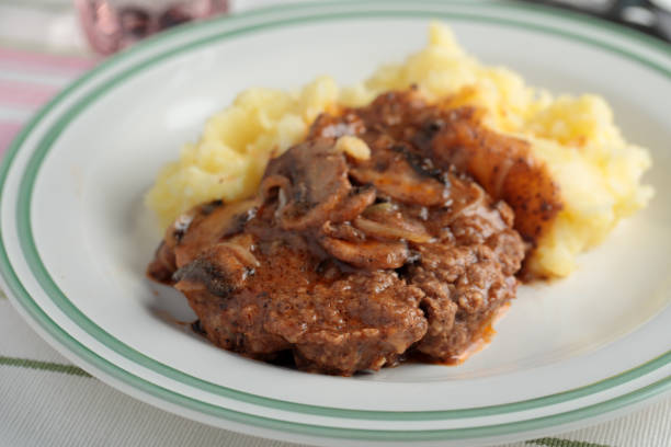 Salisbury steak with mashed potato Salisbury steak with mashed potato under mushroom gravy salisbury steak stock pictures, royalty-free photos & images