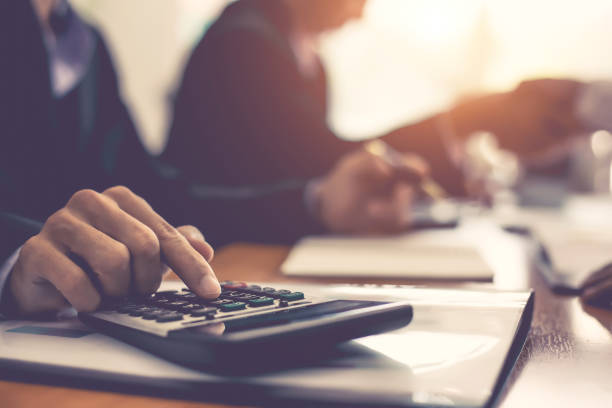 istock Close up businessman hand using calculator at meeting. 1139446842