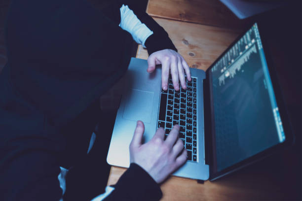 istock male hacker using laptop, breaking the government servers with personal data f 1139450431