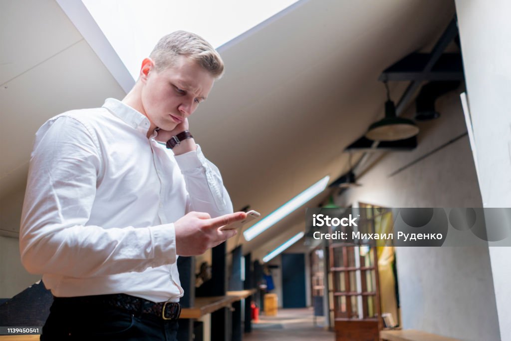 Worker Using Smartphone Young Office Worker Using His Smartphone Stock Photo - Download Image ...