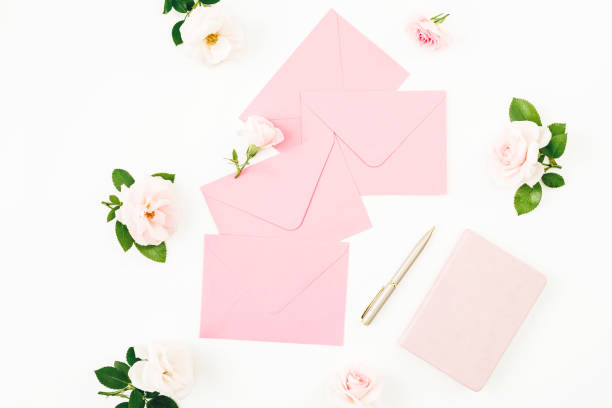 istock Frame with peonies, eucalyptus, pink envelope and diary with pen on white background. Flat lay, top view. 1139453940
