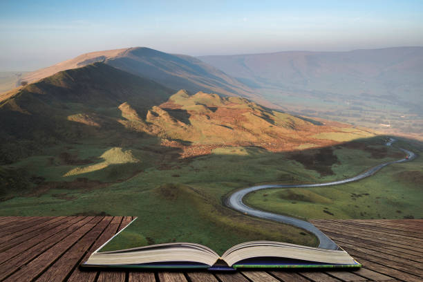 A scenic road winds its way through the Edale Valley on a foggy Winter sunrise in the Peak District in pages of open book, story telling concept A scenic road winds its way through the Edale Valley on a foggy Winter morning in the Peak District in pages of open book, story telling concept plateau concept stock pictures, royalty-free photos & images