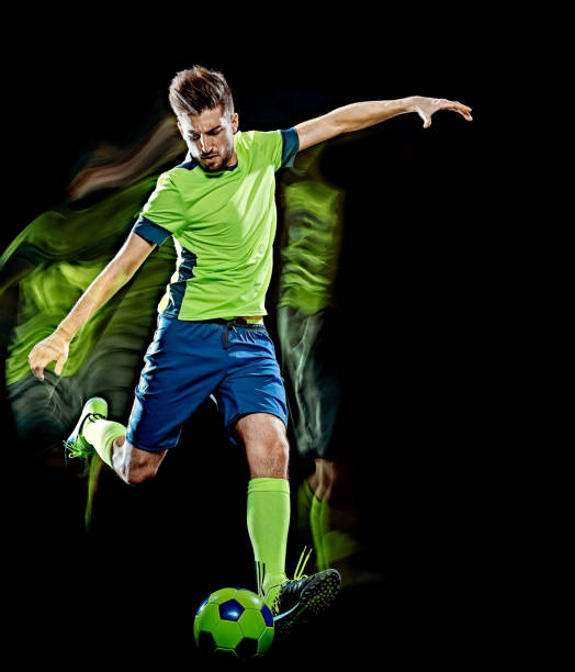 istock caucasian soccer player man isolated black background light painting 1139457724
