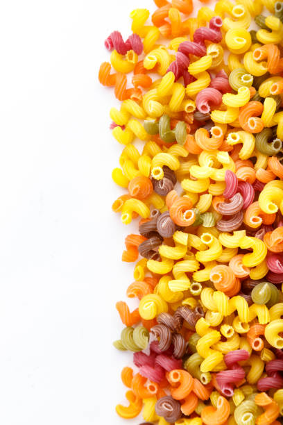 istock colorful pasta scattered on a white background. 1139458853